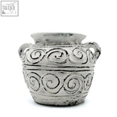 A rustic cream greek clay plant pot with two handles and decorative spiral patterns perfect for plants