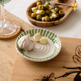 White ceramic garlic grater with green striped rim and textured center for easy ceramic garlic grating