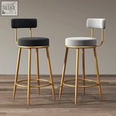 Two gregary bar stools with gold metal legs upholstered in black and light gray velvet for stylish seating