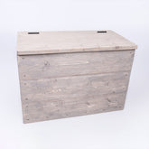 Grey rustic storage chest made of wood with a hinged lid and visible grain ideal for toys and blankets