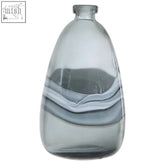 A sleek grey glass bottle vase with smooth flowing white and grey swirls in the medium halla bottle vase