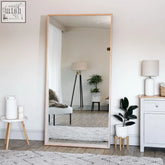A hanaka natural oak full length leaner mirror with a light wood frame measuring 200cm by 100cm