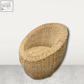Natural woven palm leaf chair in light beige with a rounded cozy shape handwoven in mozambique