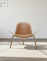 Tan leather hans wegner ch07 shell chair with curved oak wooden frame and legs for stylish seating