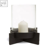 Clear glass candle holder with a black metal base in a hapax large matt black finish candle holder design