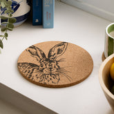 Circular portuguese cork pot stand with a detailed black ink hare illustration for stylish pot stands