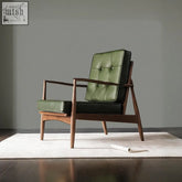 Mid-century modern harry ch23 green armchair with dark wood frame and tufted green leather upholstery on backrest
