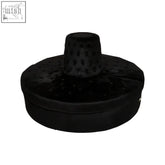Black velvet modular round ottoman with textured perforated top and rounded base for modular round sofa setup
