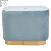 A sleek blue velvet ottoman with a tufted top and matte gold rectangular metal base for stylish seating