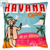 A vibrant havana needlepoint cushion with bold red and orange embroidery showing a retro cuba scene with a cigar smoking man and pink vintage car