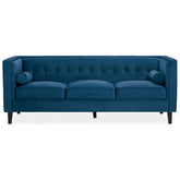Helia 3 seat blue velvet sofa with deep blue velvet upholstery, tufted back, and rolled armrests for cozy seating