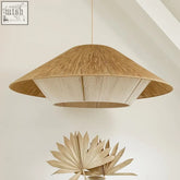 A woven conical pendant light called hempo light with natural wood tone and white inner lining