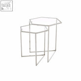 Set of two silver finish hexagon nesting tables with clear glass tops and sleek chrome metal frames for stylish living