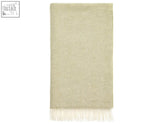 A soft sage herringbone merino lambswool throw with delicate white fringe perfect for cozying up
