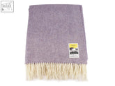 A soft lavender herringbone pure new wool throw with cream fringe and a branded label perfect for cozying up