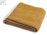 Folded mustard yellow herringbone pure new wool throw with white fringe edge 183cm including fringe perfect for double bed