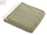 A soft olive green herringbone pure new wool throw with cream fringe 183cm including fringe perfect for a double bed