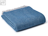 Teal hazel herringbone pure new wool throw with blue pattern and light gray fringe perfect for cozying up