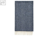 A navy blue herringbone shetland pure new wool throw with cream-colored fringe perfect for cozy warmth