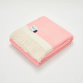 A soft candy floss pink herringbone wool blanket with cream fringe and atlantic brand label
