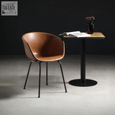 Herron a set of 2 dining chairs featuring brown leather armchair style seats with sleek black metal legs