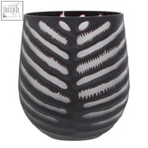 Black ceramic candle holder with white ribbed skeleton pattern resembling a black glass vase design