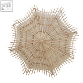Beige medium woven rattan wall light with radial starburst design made from woven bamboo in hestina style