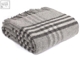 A soft gray and black striped charcoal wool throw blanket with fringed edges perfect for blanket size guide needs