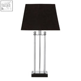 Hoffmann table lamp with black fabric shade on a stainless steel body and black granite base with vertical rods
