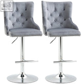 Gray velvet bar stools with button tufting chrome bases nailhead trim and swivel feature for home bar seating