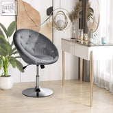 Gray tufted velvet swivel chair with chrome base featuring button tufting ideal as a chair grey or bar stool