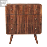 A mid-century modern honey caramel t-bar ridged wooden dresser with three drawers and four legs