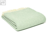 A soft mint green honeycomb pure new wool throw with subtle herringbone pattern and cream fringe edge ocean color