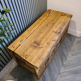 Rustic light brown solid wooden horsham storage bench with hinged lid and visible grain patterns for storage use
