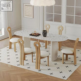 White terrazzo dining table humphry with black speckles oval top and light wood legs perfect for dining spaces