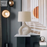 Hyung light cream-colored ceramic table lamp with sleek abstract sculptural base and soft beige fabric shade