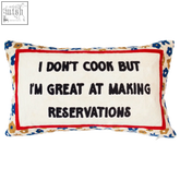 Rectangular limited edition cook needlepoint cushion with white center black text red border and blue gold floral edge