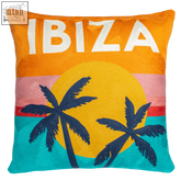 Orange ibiza needlepoint cushion with embroidered ibiza text palm trees and sunset in yellow pink red and teal