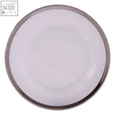 A sleek ida glass side plate made of clear glass with a polished silver rim on a round white base