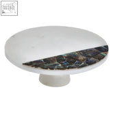 White marble knob with a paua shell half-moon inlay on the imogen cake stand base