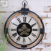 Industrial large cog clock with black metal frame light wood accents cream face roman numerals and brass gears