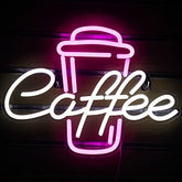 A pink neon light coffee neon sign shaped like a coffee cup with white cursive text perfect for coffee shop decor