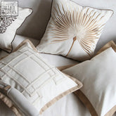 Cream-colored irma cushion cotton throw pillows with gold beige embroidery palm frond lattice and black floral design