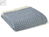A folded gray and white textured wool throw with cream fringe from isobel crescent blue slate drapers collection