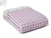 A soft lavender and white jacquard spot pure new wool throw blanket with textured weave and cream fringe perfect for cozy spots