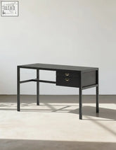 Black minimalist jottergoods office desk with two drawers brass handles and slender metal legs for any office space