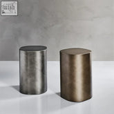 Two junko side tables with a brushed metallic finish in dark gray and warm bronze perfect for modern spaces