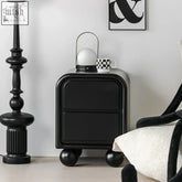 Black kagawa side table with rounded corners and neat drawers on spherical casters for bedroom storage