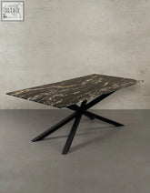 Kamara dining table with dark veined marble top and sleek black metal x shaped legs perfect for marble dining
