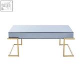 Modern kaso coffee table with sleek mirrored top and gold-toned geometric legs for stylish living spaces